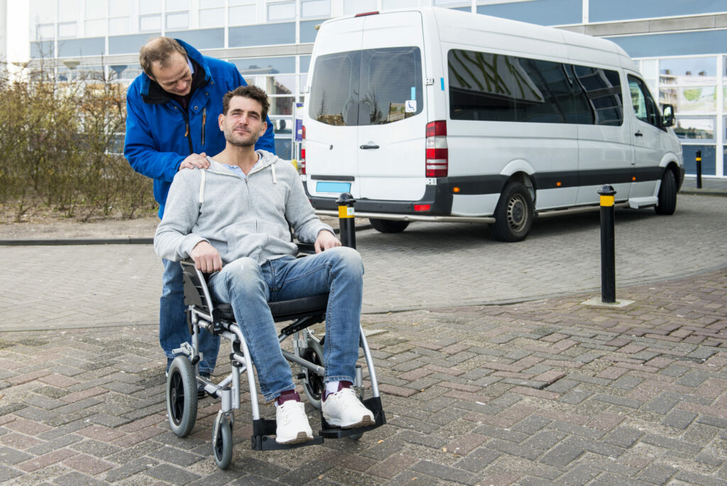 Man in rolstoel met vervoerder